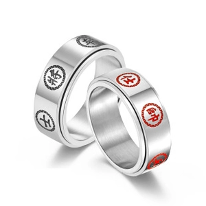 Macro detail of Chinese chess themed couple rings with engraved red and black characters