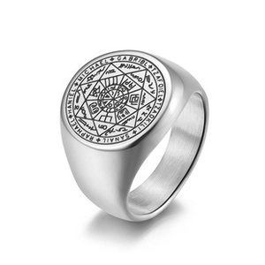 Macro detail of silver stainless steel signet ring with engraved archangel symbols