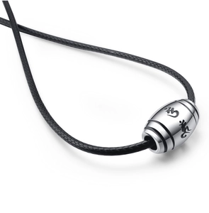 Macro shot of silver barrel pendant with engraved mantras on black braided cord