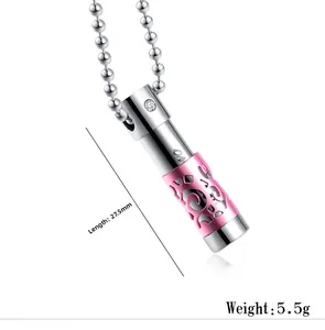 Detail view of pink filigree perfume bottle pendant with 27.5mm length and 5.5g weight