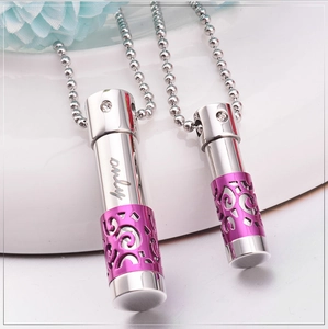 Macro detail of couple perfume bottle necklaces with purple hollow pattern and only engraving