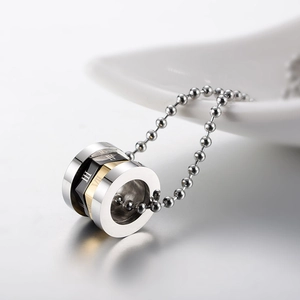 Close-up of rotatable Roman numeral pendant with silver gold and black rings