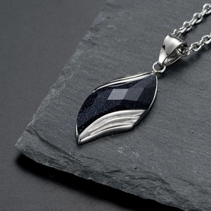 Macro view of blue sand stone angel eye leaf pendant with faceted texture on stone