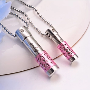Pair of cylindrical perfume bottle necklaces with pink filigree and crystal detail
