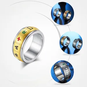 Detail of spinning stainless steel mahjong ring with golden engraved Chinese characters