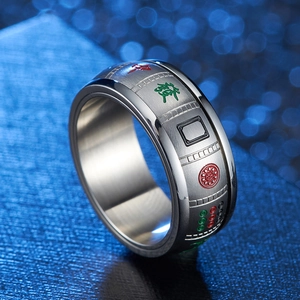 Detailed view of stainless steel mahjong ring with red and green etched patterns