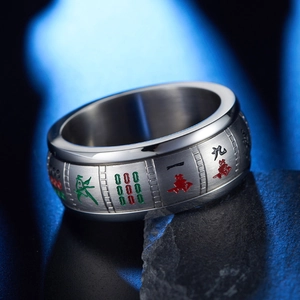 Close-up of brushed stainless steel mahjong ring with red and green engraved tiles