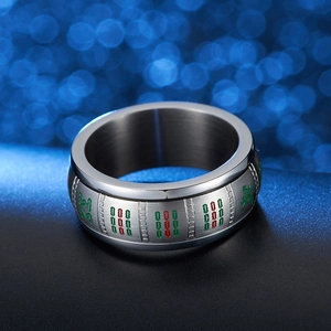 Macro shot of silver stainless steel ring with red and green mahjong patterns