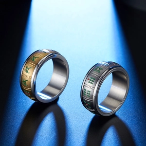 Detailed macro view of metal rings with colorful traditional Mahjong tile pattern engraving