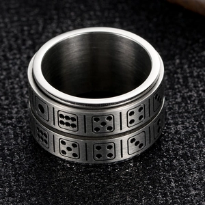 Macro view of rotatable stainless steel spinner ring with engraved dice patterns