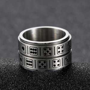 Brushed stainless steel spinner ring featuring engraved dice patterns for stress relief