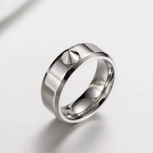Detailed view of silver stainless steel ring featuring a sharp conical rivet spike design