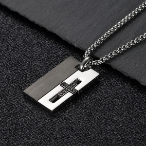 Detail of cross pendant featuring dual-tone matte black and polished silver stainless steel