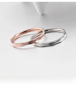 Makroaufnahme minimalistischer Ringe in Roségold und Silber mit facettierter Oberfläche