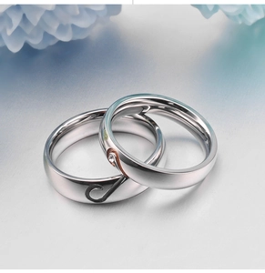Polished stainless steel couple rings with interlocking heart design and single diamond inlay