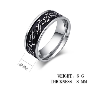 Detailed macro view of 8mm wide stainless steel ring with black dragon flame patterns