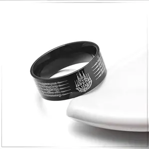 Black titanium steel ring with silver Thai scripture engravings on white display stand