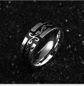 Macro shot of vintage dragon pattern ring in stainless steel with cross totem detail