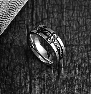 Detailed macro view of retro stainless steel ring with black cross totem pattern