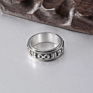 Vintage rotating mantra ring in stainless steel with carved script and beaded edges