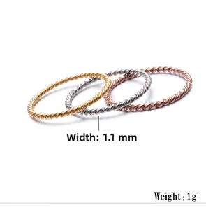 Detailed view of 1.1mm twisted rope stackable rings in gold, silver, and rose gold