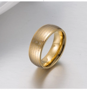 Macro shot of titanium steel ring with laser-engraved Buddhist scripture and gold finish