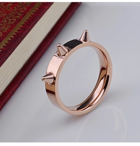 Polished rose gold punk ring featuring three sharp vertical rivets in a spike design