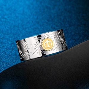 Macro shot of vintage titanium steel feather ring with golden eagle emblem and detailed texture