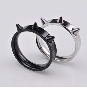 Close-up of hip hop style spike rings in black and silver with reflective metallic finish