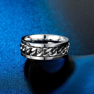Macro shot of a stainless steel ring with a Cuban chain inlay on a blue-black gradient background