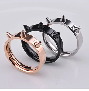 Close-up of hip-hop punk spike rings in polished rose gold, silver, and black finish