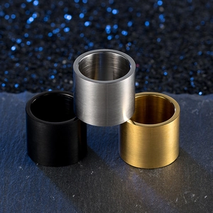 Macro detail of brushed titanium steel rings in gold, silver, and black finish
