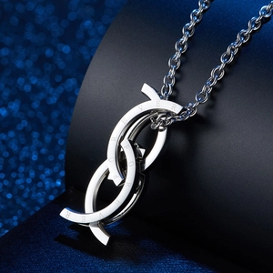 Macro shot of polished silver necklace pendant with Forever engraving on metal ring