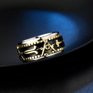 Macro detail of rotatable stainless steel Freemason ring with gold embossed symbols