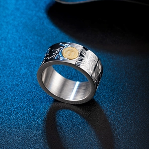 Men's wide silver ring with golden sun symbol and embossed floral patterns