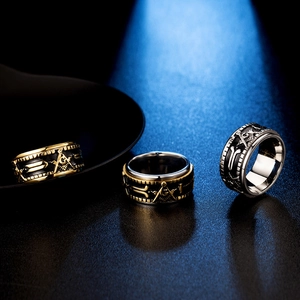 Detailed close-up of rotating Freemason rings in gold, black and silver titanium steel