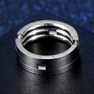 Macro shot of silver stainless steel ring with FOREVER engraving and hollow details