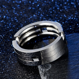 Macro shot of stainless steel folding ring with Love Forever engraving and mechanical layers