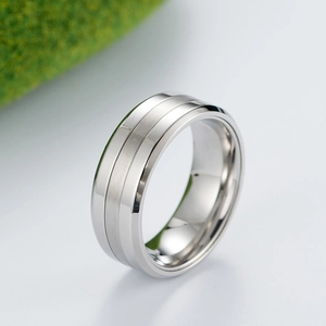 Macro view of men's stainless steel ring showing brushed finish and polished edges