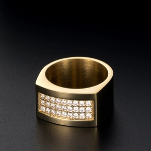 Close-up of golden titanium ring with triple row of zircon inlay and brushed finish