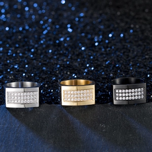 Detailed view of wide men's rings in silver, gold, and black with three rows of pavé zircon