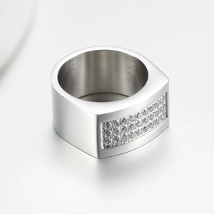 Macro view of brushed titanium steel ring featuring triple rows of cubic zirconia stones
