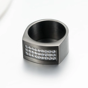 Macro view of brushed gunmetal mens ring featuring triple rows of shimmering white zircons