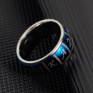 Detail shot of rotatable poker ring featuring blue plating and engraved card symbols