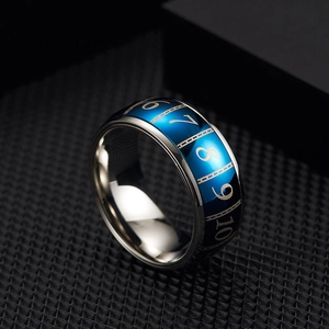 Macro shot of rotatable stainless steel ring with blue laser-engraved poker numbers
