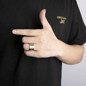 Macro shot of gold stainless steel ring featuring glowing numeric engraving on rotatable band