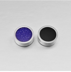 Dettaglio macro di orecchini magnetici in acciaio con inserto galassia blu e nero opaco