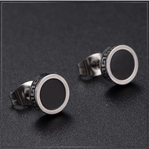 Vintage silver stainless steel stud earrings with Greek key pattern on dark background