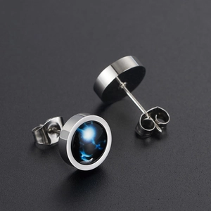 Glow-in-the-dark stainless steel stud earrings with blue nebula galaxy pattern