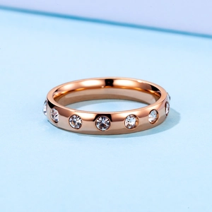 Minimalist rose gold stainless steel ring featuring circular cut sparkling crystals